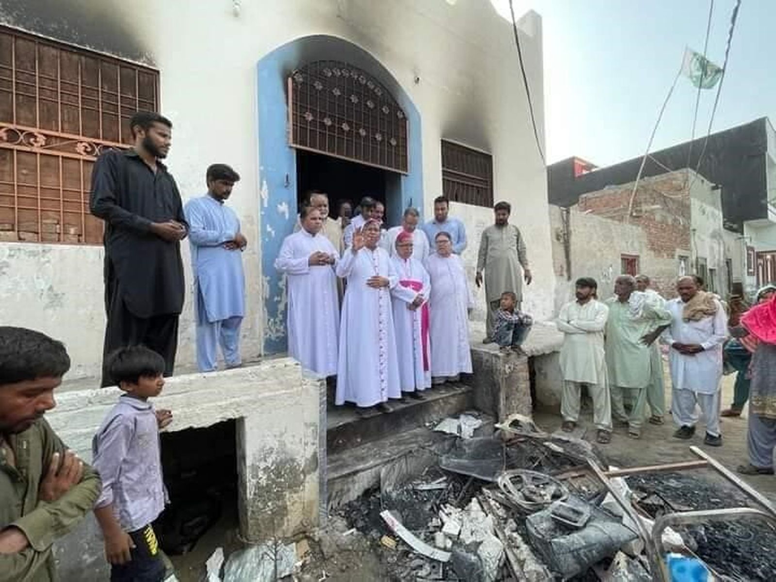 Oración frente a una iglesia quemada por las turbas islámicas en Pakistán